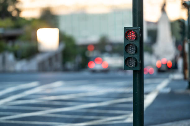 istock Red traffic light at an urban intersection during twilight hours 2181388988
