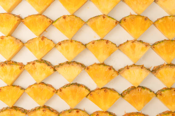 Pineapple juicy yellow slices on a white background. Top view.