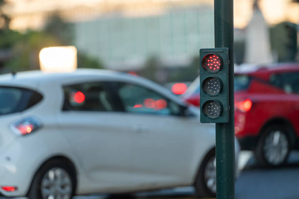 istock Traffic signal with red light near busy intersection during early evening rush hour 2181389021