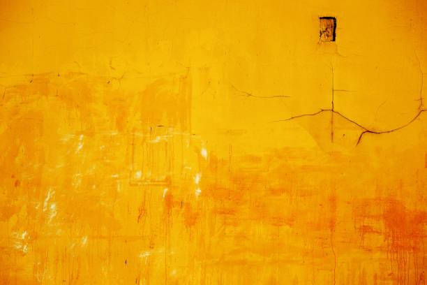Texture of yellow concrete wall as background and design element