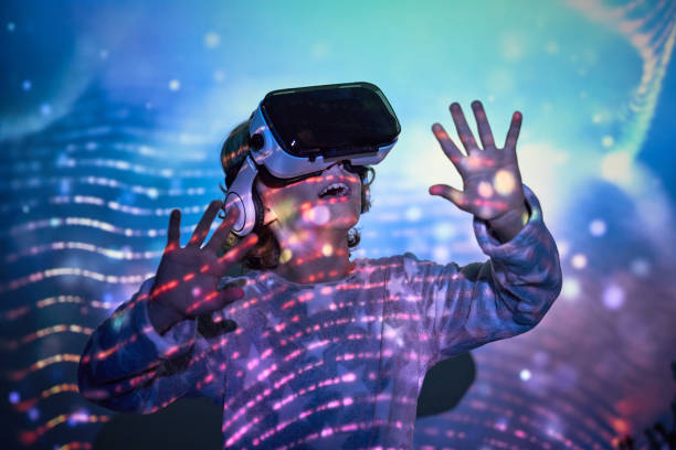 istock Amazed smiling child looking up in VR goggles 2181392338