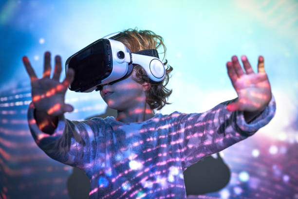 istock Cute child with arms stretched forward exploring cyberspace in V 2181392339
