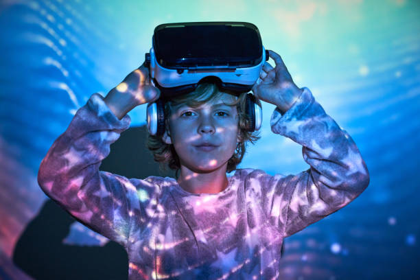 istock Adorable child taking off VR goggles and looking at camera again 2181392340