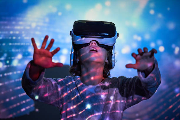 istock Astonished kid interacting with virtual reality in goggles 2181392371