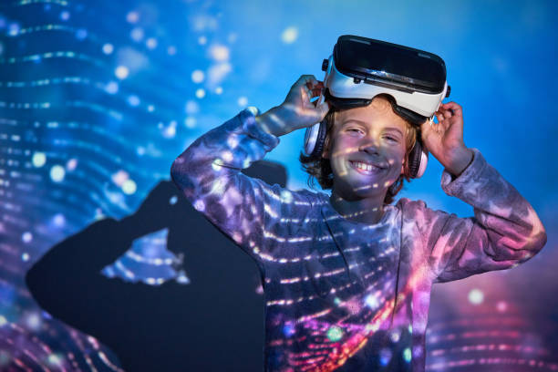 istock Cheerful child taking off VR headset and smiling at camera 2181392414