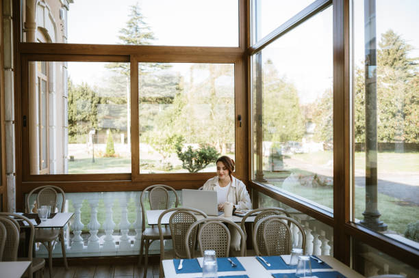 istock Woman with laptop in a cafeteria 2181393842