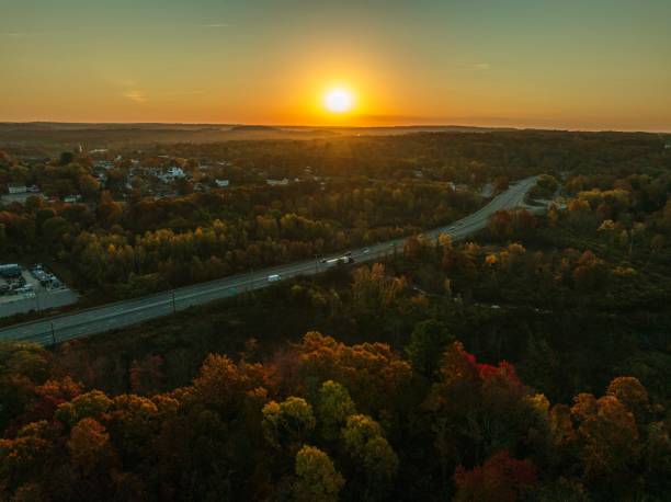 istock Highway through autumn forest at sunset. 2181394438