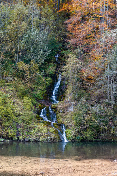 istock Waterfall in the autumn forest. 2181395524