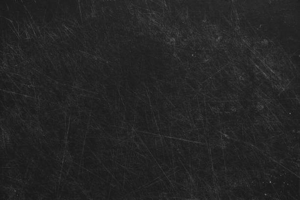 Plastic cutting black board all in cuts from a knife, board in scratches