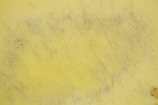 istock Plastic yellow cutting board all in cuts from a knife, the board 2181398418