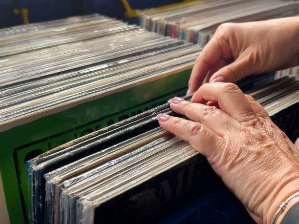 istock Female hand picking vinyl records. 2181398942