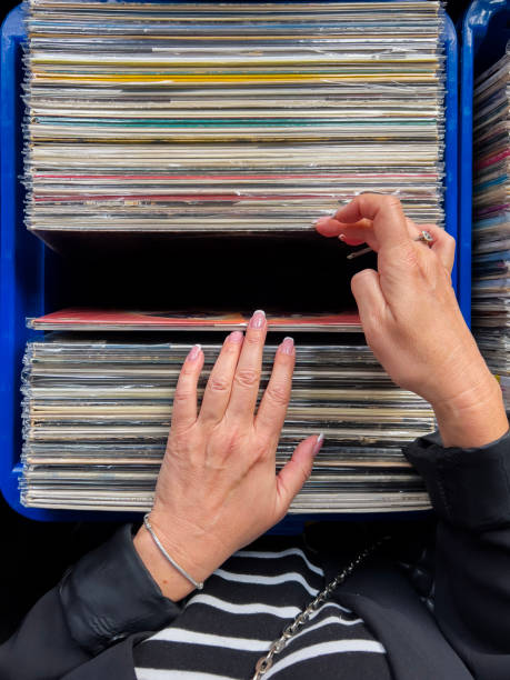istock Female hand picking vinyl records. 2181398997