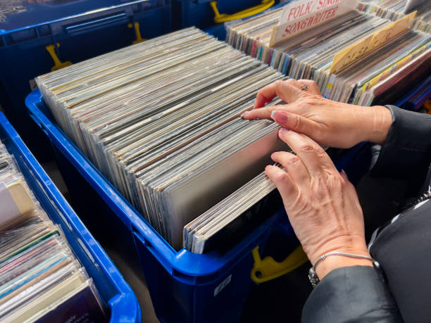 istock Female hand picking vinyl records. 2181399024