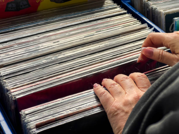 istock Female hand picking vinyl records. 2181399066
