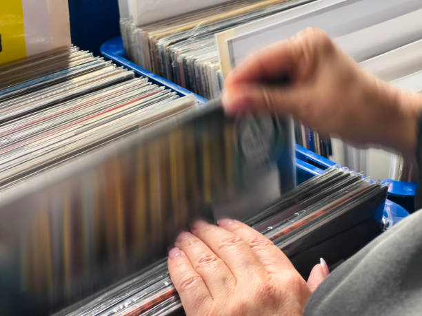 Female hand picking vinyl records.