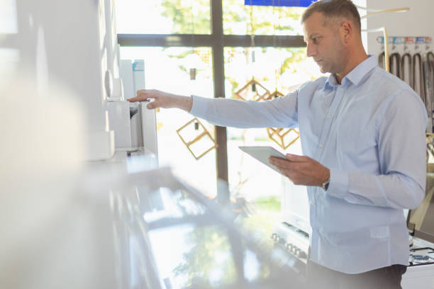 istock Store owner taking inventory within the home appliance store 2181400429