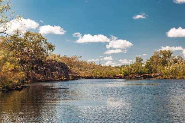istock The Katherine River reflects the clear blue sky, bordered by vibrant greenery and rocky outcrops 2181409848