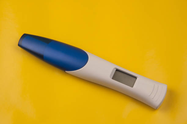 personal perspective of hands of old woman holding a positive pregnancy test.good news for grandmother.femininity,fertility and family.