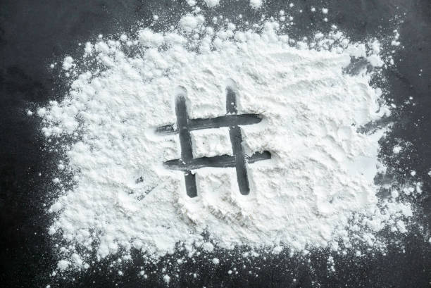 istock Hashtag symbol written on a sprinkled powder on teh table. 2181417378