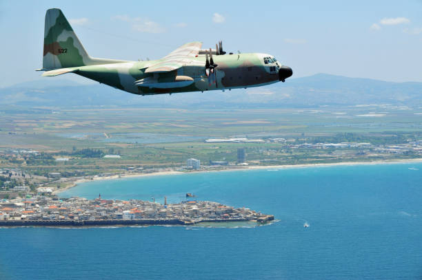 Acer - May 10 2011: Lockhead C-130 Hercules fly above Akko Israel.The C-130 was used in the 1976 Entebbe raid in which Israeli commando forces performed a surprise operation at Entebbe Airport, Uganda.