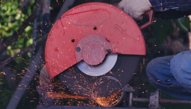 istock Hot flame welding metal work cutting fire iron workshop. Welding machine iron metal sparking. Locksmith using Welding machine cutting metal processing grinder. Close up hands Sparks in metalworking 2181421825