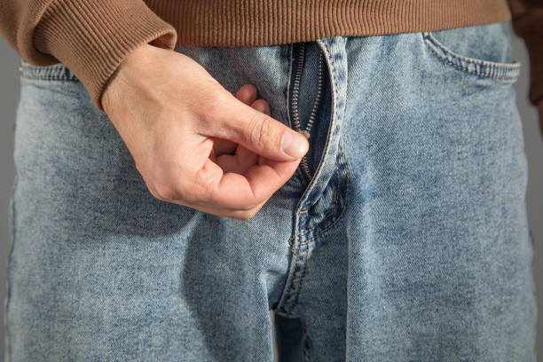 istock Man zipping up denim jeans. 2181425740