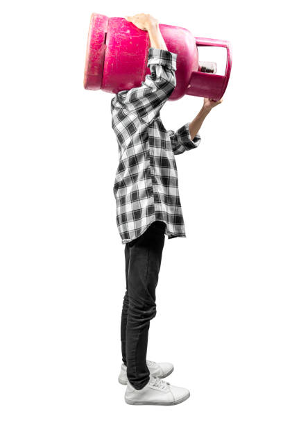 istock Man is carrying a pink gas cylinder on his shoulder 2181426378