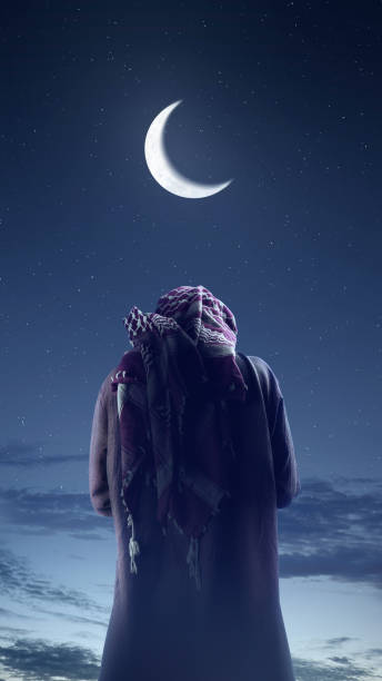 istock Religious old Muslim man praying (salat) with crescent moon on the sky 2181427534