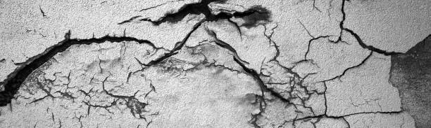istock Surface of white concrete wall with cracks and holes. Abstract pattern of concrete wall 2181427994