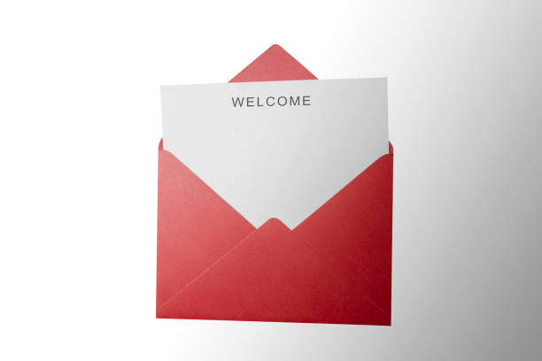 istock Top view of red envelope and postcard with white card with words Welcome on it. Welcome greeting for invitation, express hospitality, greet, show acceptance 2181432765