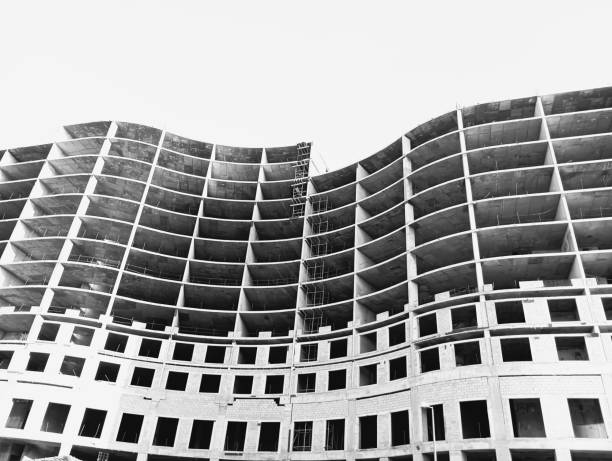 Under construction building in black and white color, low angle shot background with clear sky.