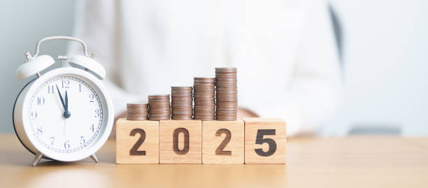 istock Happy New Year 2025 with clock and coins stack arrangement. Money Saving for Future Plan, Retirement fund, Pension, Investment, Wealth Business, Financial and countdown concepts 2181439656
