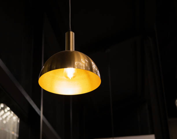 istock gold incandescent lamp On the black ceiling in the cafe 2181441432