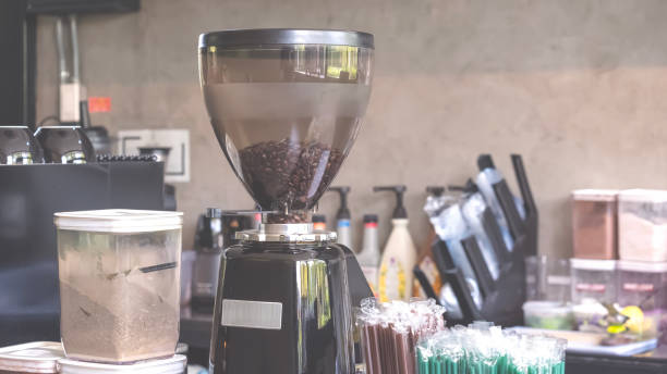 istock Electric coffee machine and black case with grinder container on counter inside of modern loft coffee shop 2181444966
