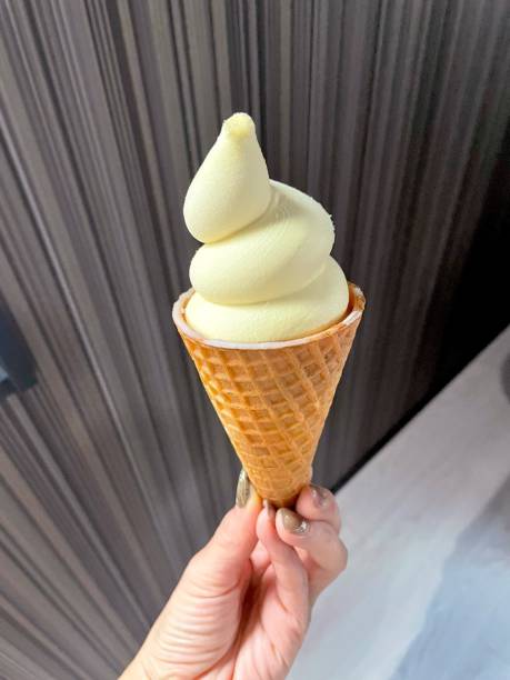 istock Creamy ice cream scooped into a crunchy waffle cone, melting slightly under warm sunlight. The perfect treat with classic flavors and a nostalgic touch. 2181446775