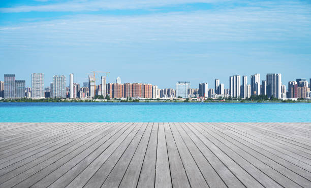 istock Empty boardwalk with modern urban skyline and sunny blue sky background 2181449430