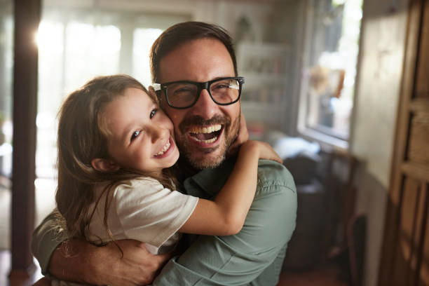 istock Happy single father and daughter embracing at home. 2181449518