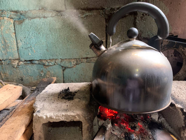 istock Whistling kettle boiling water in fire and wood copy space 2181449734
