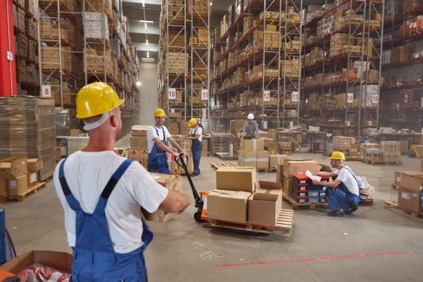 istock Team of happy workers working with packages in storage room. 2181455773