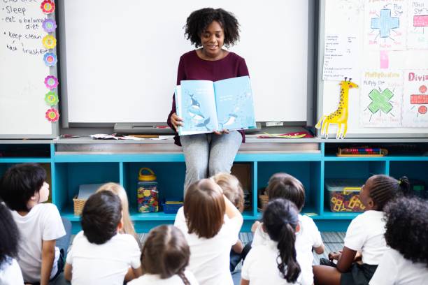 istock Teacher reading to diverse group of children. 2181455904