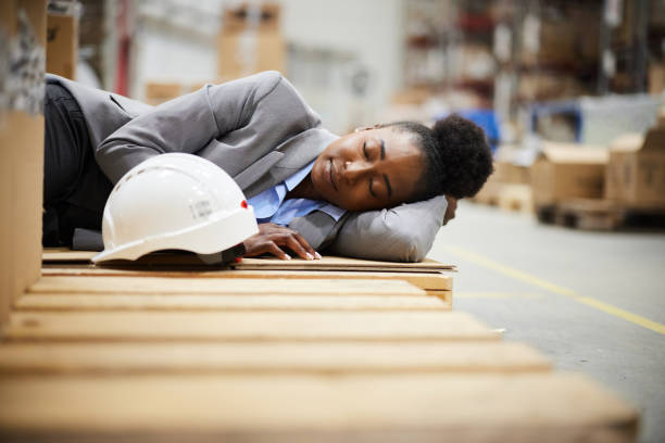 istock Tired black female manager taking a nap on a break in storage room. 2181456115