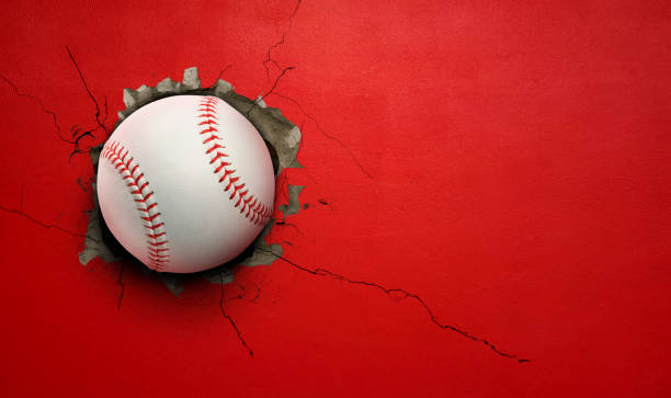 istock Baseball breaks through red concrete wall concept of power, strength. 2181457600