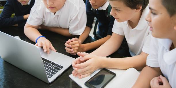 istock Group of student focus on laptop in online learning classroom, diverse students in school uniforms learn online. 2181457607