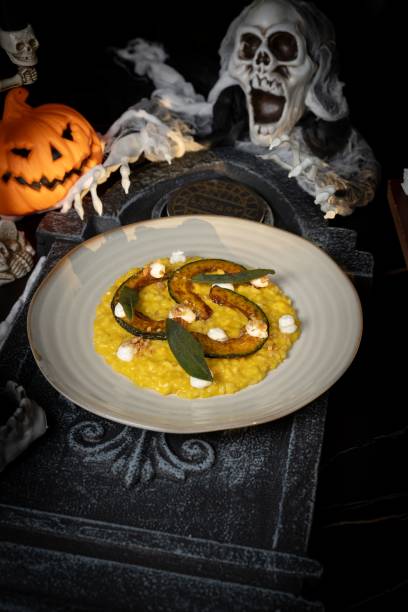 istock Halloween-themed pumpkin risotto with spooky decor. 2181458374