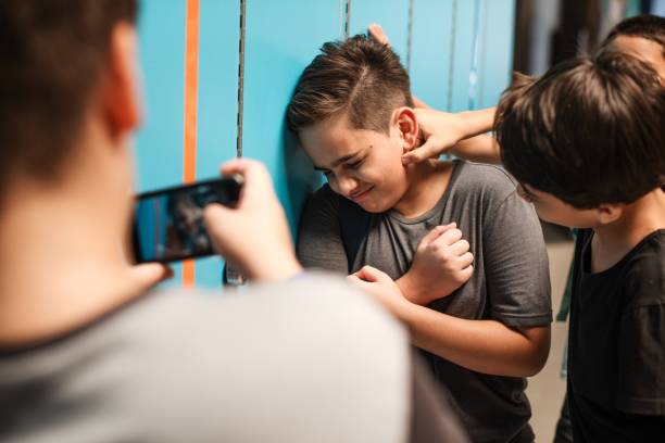 istock A young boy is being bullied by peers at school. 2181458819