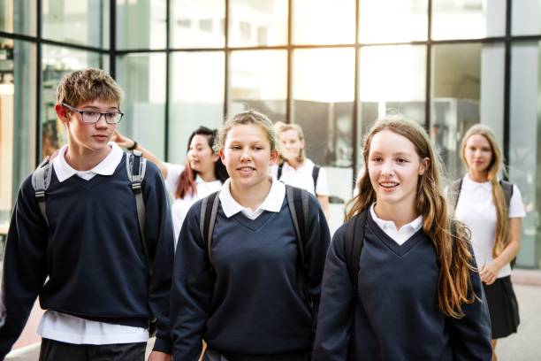 istock Group of diverse happy students in school uniform walk together after school class. 2181459380