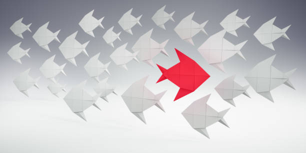 istock Group of white Fishes with red Leader 2181461489