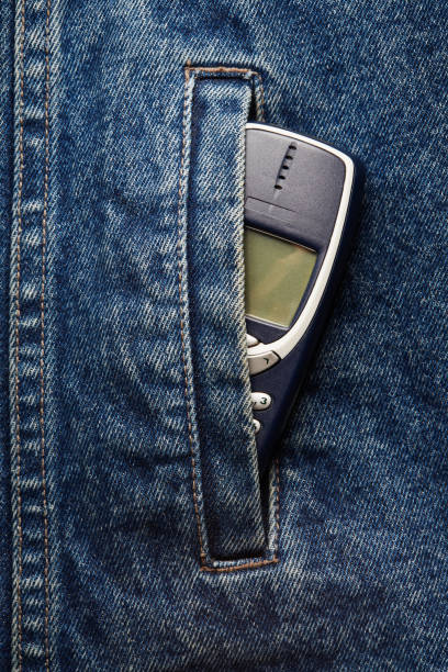 istock Old-fashioned push-button phone inside of denim jcket's pocket 2181462870