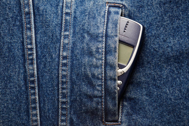 istock Old-fashioned push-button phone inside of denim jcket's pocket 2181462873