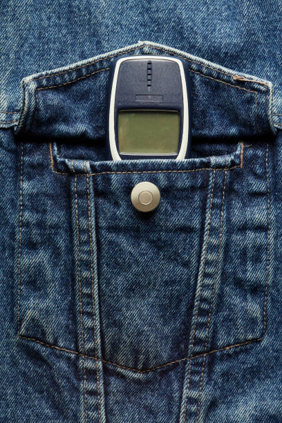 istock Old-fashioned push-button phone inside of denim jcket's pocket 2181463021